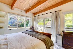 a bedroom with a bed and two windows at Luxury Vacation Rental in Oakland, California! in Oakland