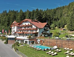 ein Hotel mit einem Pool und einem Resort in der Unterkunft Granpanorama Wellnesshotel Sambergerhof Superior in Villanders