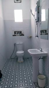 a white bathroom with a sink and a toilet at SD View Hotel in Vang Vieng