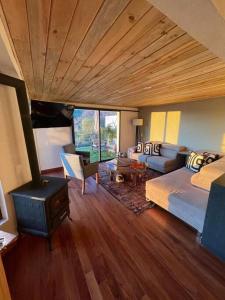 a bedroom with a fireplace and a bed and a stove at Hermosa casa privada con jacuzzi y una vista espectacular al lago in Valle de Bravo