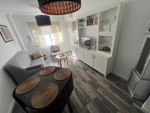 a living room with a table and a couch at Casa Ana in Sanlúcar de Barrameda