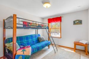 a bedroom with a bunk bed and a couch at Dogwood Retreat in New Lisbon