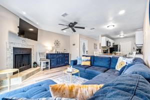 a living room with a blue couch and a fireplace at Bay Street Bliss in Gulf Breeze