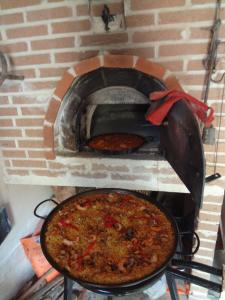 a pizza is being cooked in a brick oven at Casa rural El Balcón del Tajuña in Valfermoso de Tajuña