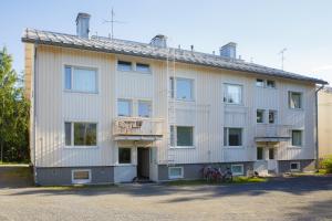 a large white building with bikes parked in front of it at Hannula in Kuopio