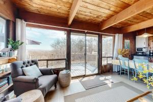 a living room with a couch and a large window at Lobsterville Landing in Lobsterville