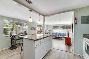a kitchen with white cabinets and a counter top at Beach Cottage on Jones in Tybee Island