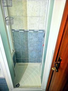 eine Dusche im Bad mit Glastür in der Unterkunft Casa in mansarda con terrazza in Caronno Pertusella