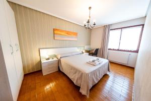 Un dormitorio con una cama y una mesa con toallas. en CASA RURAL BARAZAR en San Sebastián