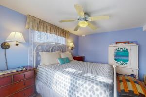 a bedroom with a bed and a ceiling fan at The Cottage at Long Sands in York