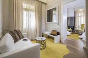 a white living room with a white couch and a living room at 3 Sixty Hotel & Suites in Nafplio