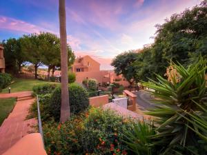 a view of a yard with flowers and trees at Marbella Elviria apartment in Marbella