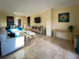 a living room with a couch and a table at Marbella Elviria apartment in Marbella