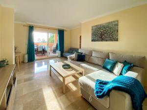 a living room with a couch and a table at Marbella Elviria apartment in Marbella
