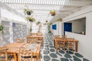 a dining room with wooden tables and chairs at Pousada Villa Santô in Guarujá