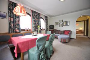 a living room with a table and a couch at Apparthotel Restaurant Steiners in Eben im Pongau