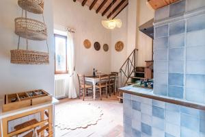a kitchen with a table and a dining room at Estia - In Parulia Country House in Arezzo