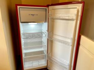 um frigorífico vazio com a porta aberta numa cozinha em Agriturismo Cascina Clavarezza em Valbravenna