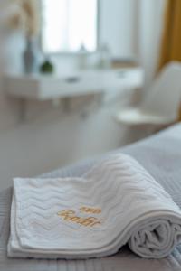 een witte handdoek bovenop een bed bij Apartment Radić-perfect location for summer activities in Trogir