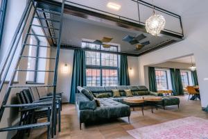 a living room with a ladder and a couch at vila FABRIKA in Vyhne