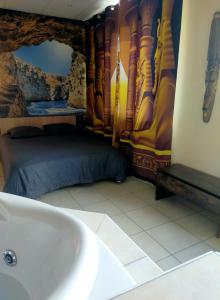 a bathroom with a bath tub and a bed at Love Paradise by Karen's Room Service in Forbach