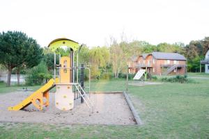 a playground with a slide in a park at Appartement Shakespeare 15 in Chaveignes