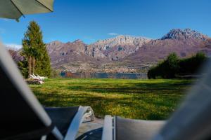 a view of a lawn with mountains in the background at Villa Oliveto apartments in Oliveto Lario