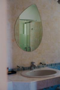 a bathroom with a sink and a mirror at Villa Oliveto apartments in Oliveto Lario