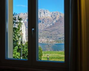 a view of a mountain from a window at Villa Oliveto apartments in Oliveto Lario