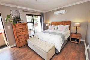 a bedroom with a large bed and a large window at Elroys in Sandton