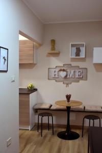 a dining room with a table and two stools at Kosentia Bed and Breakfast in Cosenza