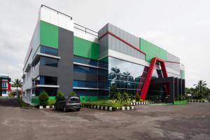 a car parked in front of a building at Super Collection O 3431 Hotel Alpha Bandara in Palembang