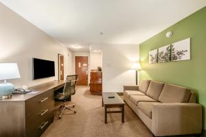a living room with a couch and a desk at Sleep Inn & Suites Ruston Near University in Ruston