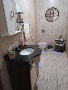 a bathroom with a sink and a toilet at Hospedagem Tia Marli in Pomerode +7 photos