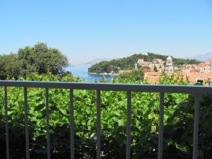a view from a balcony of a town and a body of water at Guesthouse Marija in Cavtat