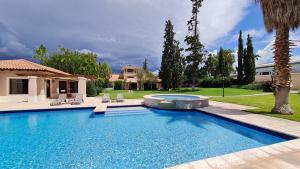 a swimming pool in a yard with chairs and a house at Casa Agostino - Luxury wine resort in Mendoza
