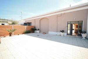 ein Gebäude mit einer Terrasse mit Topfpflanzen darauf in der Unterkunft La conigliera in Brindisi