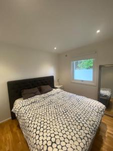 a bedroom with a large bed and a window at Gästhus i Borås (Guest House) in Borås