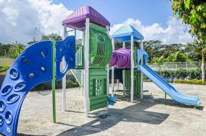 a group of playground equipment in a park at Beach Holidays at Marina Villa in Saint Annʼs Bay