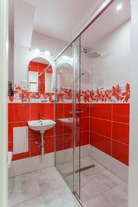 czerwona łazienka z umywalką i prysznicem w obiekcie Apartament pod Świerkiem - Pet Friendly - 2 osobne pokoje dla max 5 osób - Space Apart w Jeleniej Górze