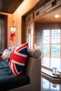 a living room with a blue couch with patriotic pillows at 宜蘭 星居 包層公寓 in Yilan City