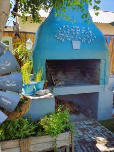 an outdoor pizza oven in a garden with plants at Rest on 29 Rus in Oudtshoorn