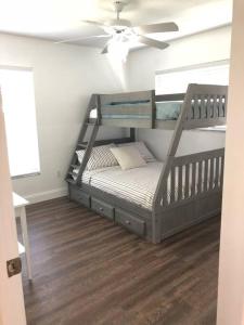 a bunk bed in a room with a ceiling fan at Beautiful Home across the street from Lake June! in Lake Placid