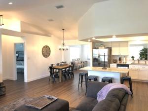 a living room and kitchen with a couch and a table at Beautiful Home across the street from Lake June! in Lake Placid