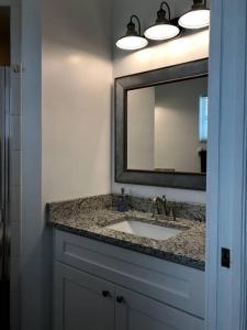a bathroom with a sink and a mirror at Beautiful Home across the street from Lake June! in Lake Placid +37 photos