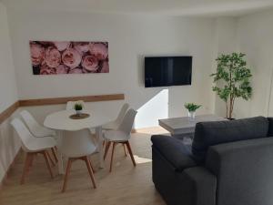a living room with a couch and a table at Apartamentos O Grove Centro in O Grove