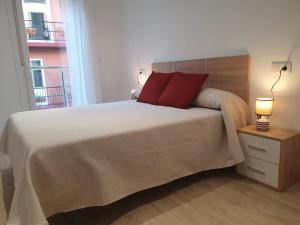 A bed or beds in a room at Apartamentos O Grove Centro