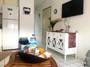 a kitchen with a table with a bottle of water on it at Appartement lumineux à Les Trois-Îlets - 70 m² - Vue sur mer in Les Trois-Îlets