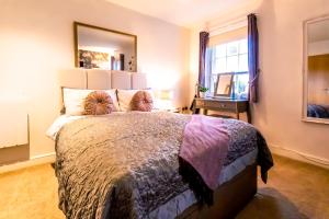 a bedroom with a large bed with a large mirror at Domus House Studio Apartments Chester city centre by Rework Accommodation in Chester