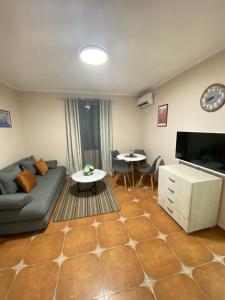 a living room with a couch and a table at Aquata Apartments in Tivat